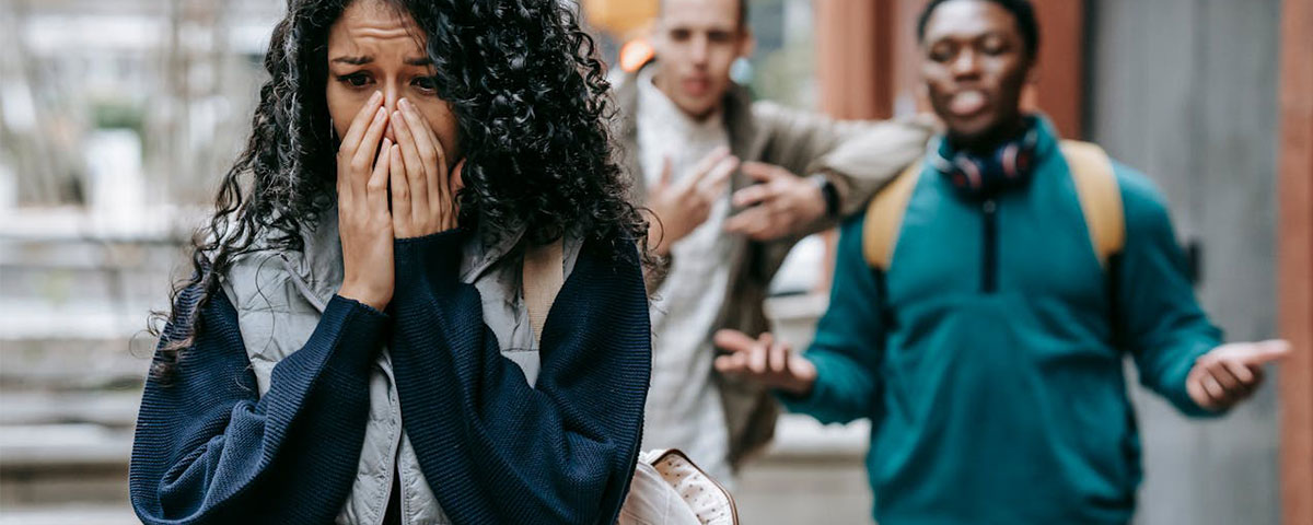 two male students harassing a female student