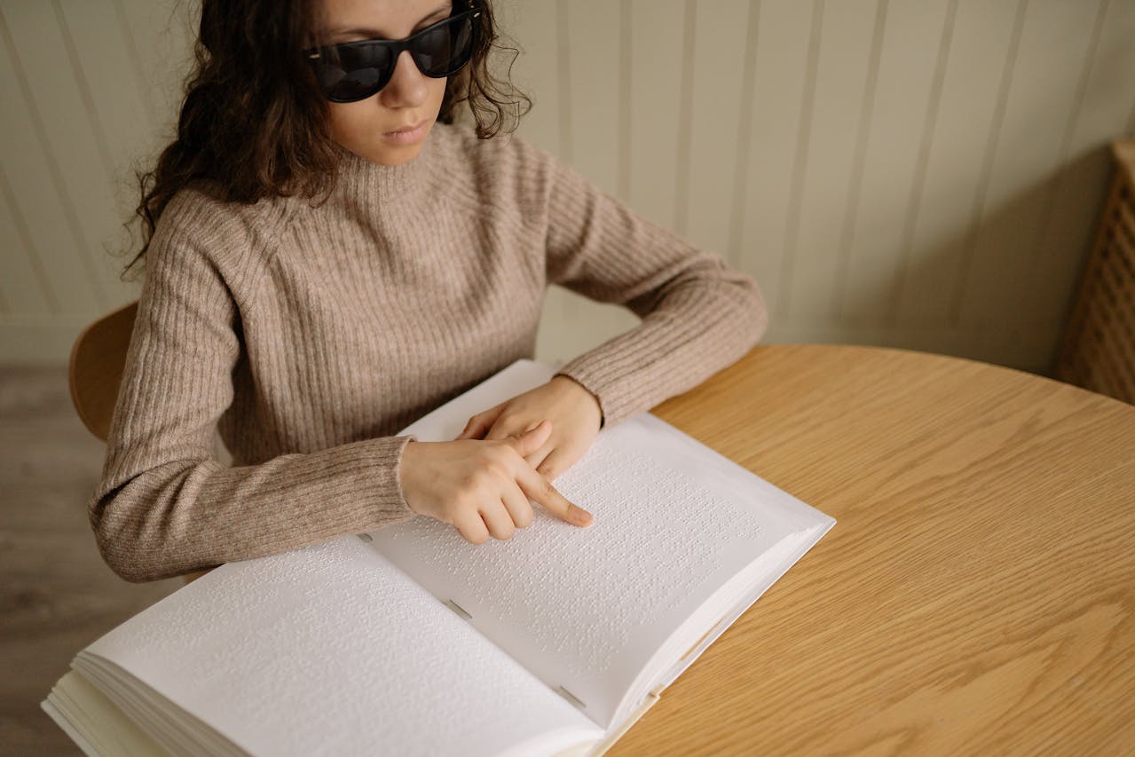 a girl using a braille book