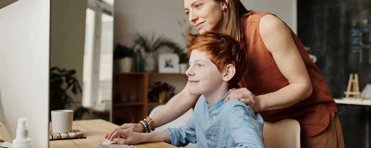 parent and child looking at a computer