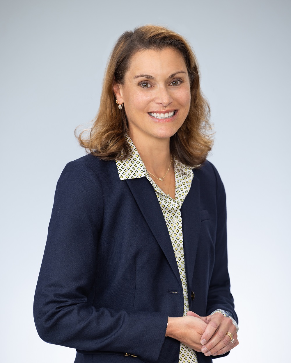 Professional headshot of Christina Grube, Document Review Specialist of School Liability Expert Group, in a navy blue suit jacket