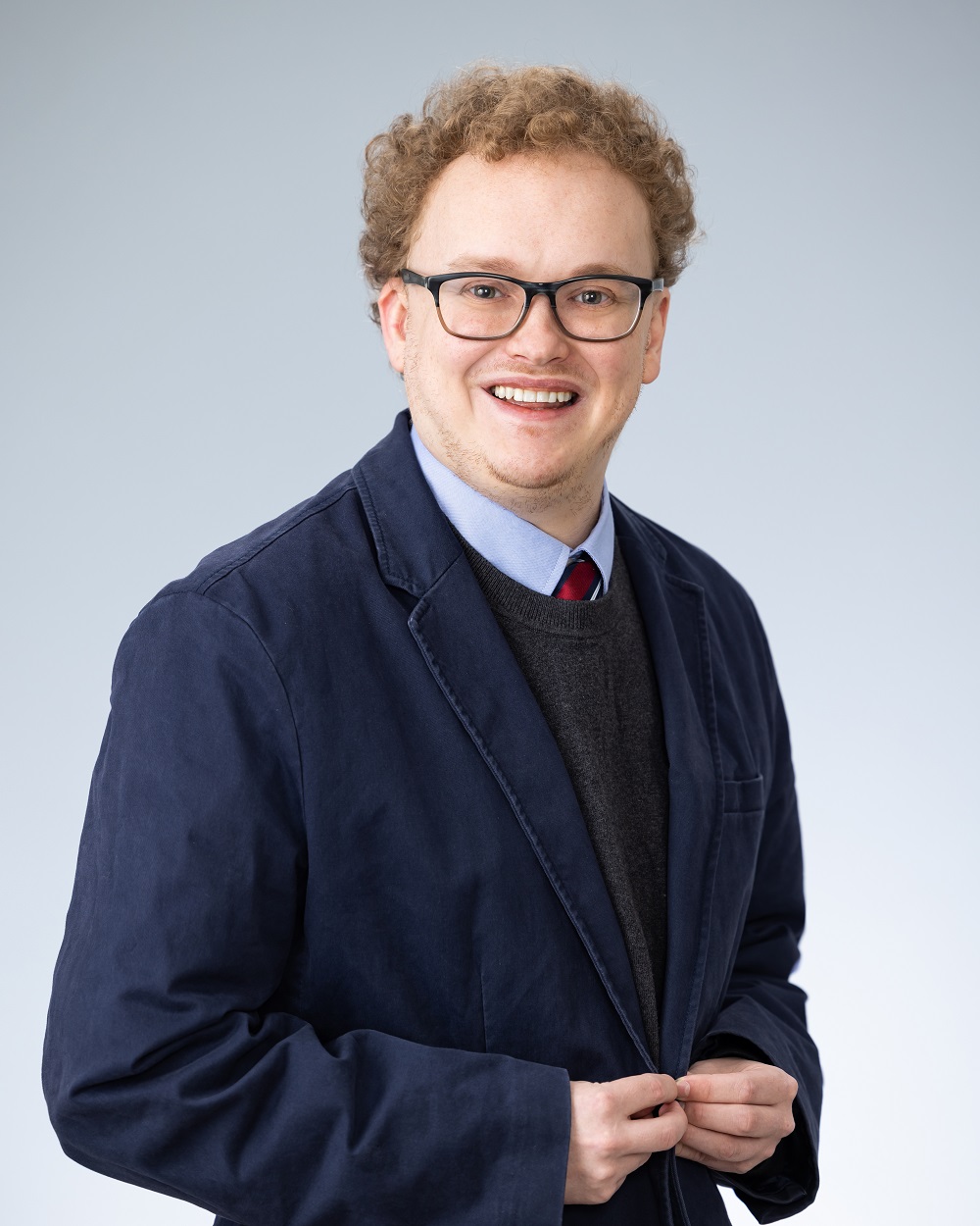 Professional headshot of Peter Graham, Legal assistant of School Liability Expert Group, in a navy blue suit jacket