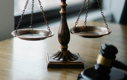 a gavel and scale of justice on a table