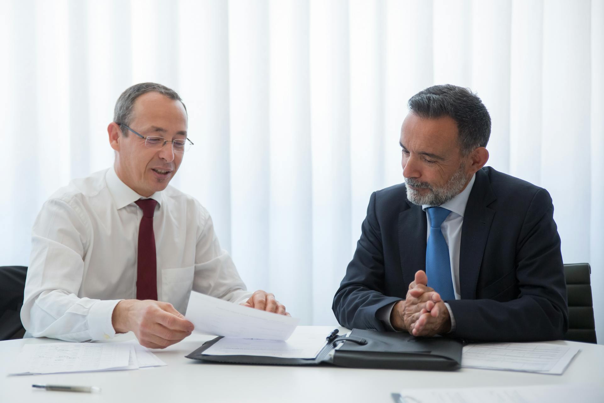 Two attorneys looking at documents in an office