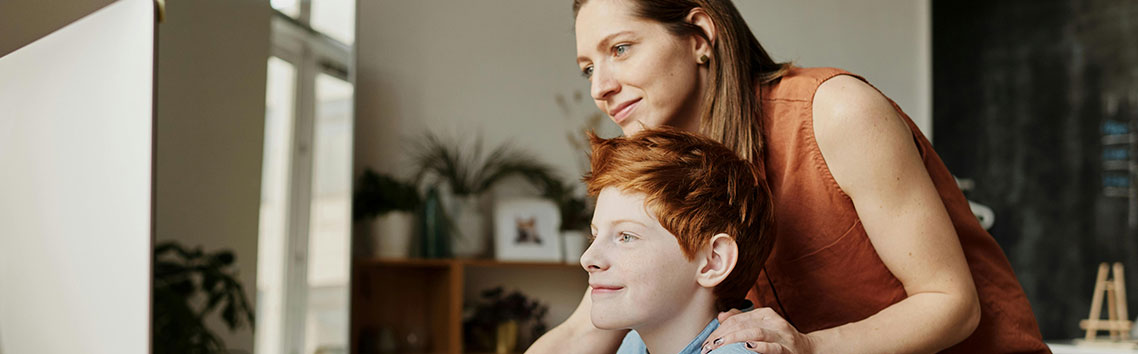 parent and child looking at a computer