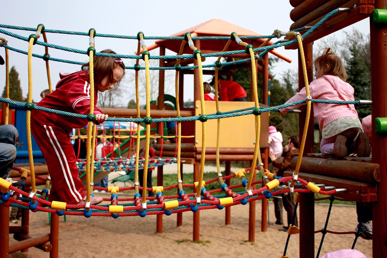 Young children playing on a rope bridge