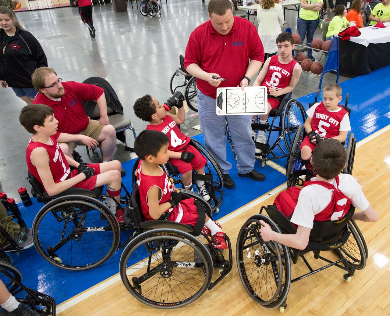 A sports team of children with disabilities in wheelchairs