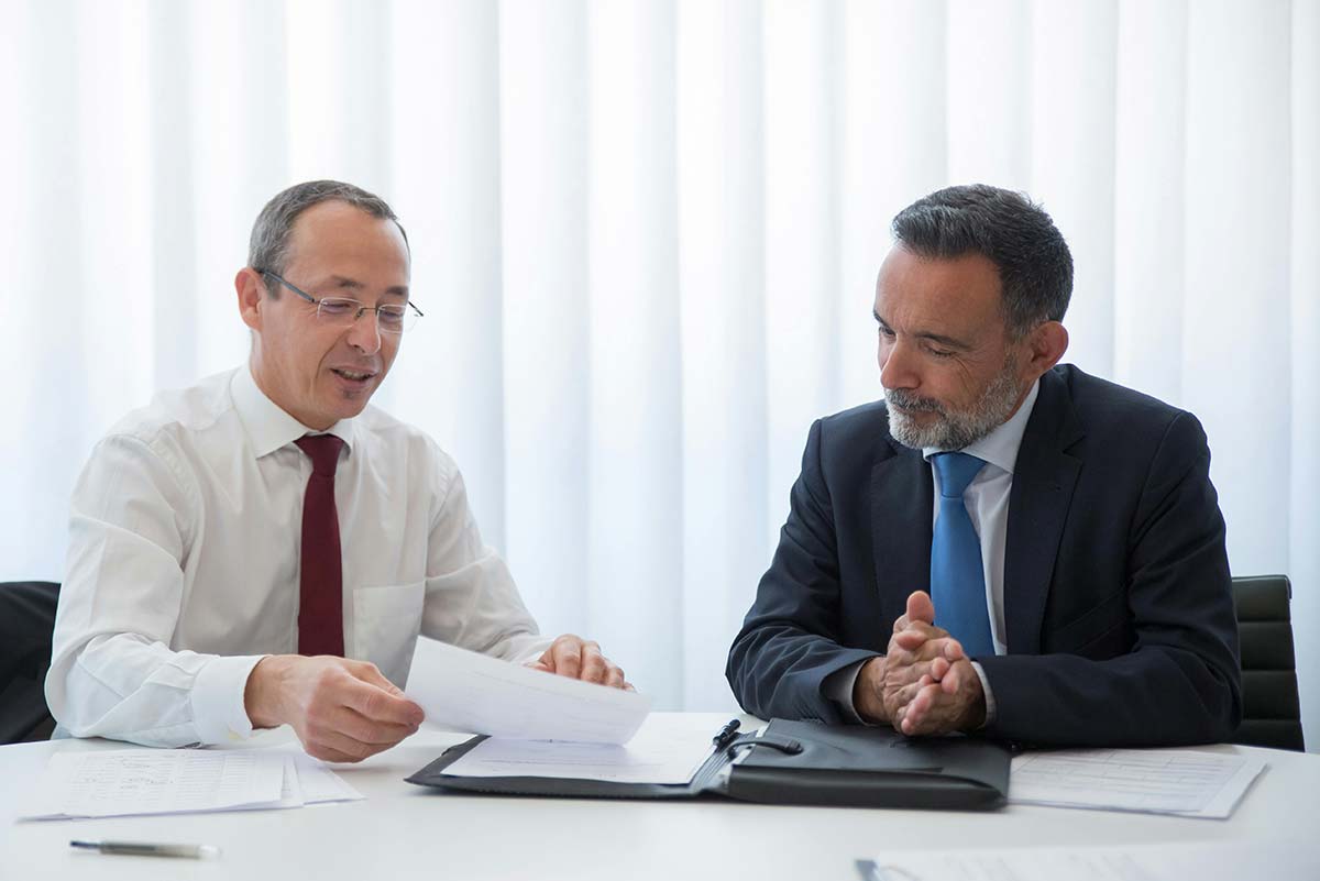 two people looking at documents