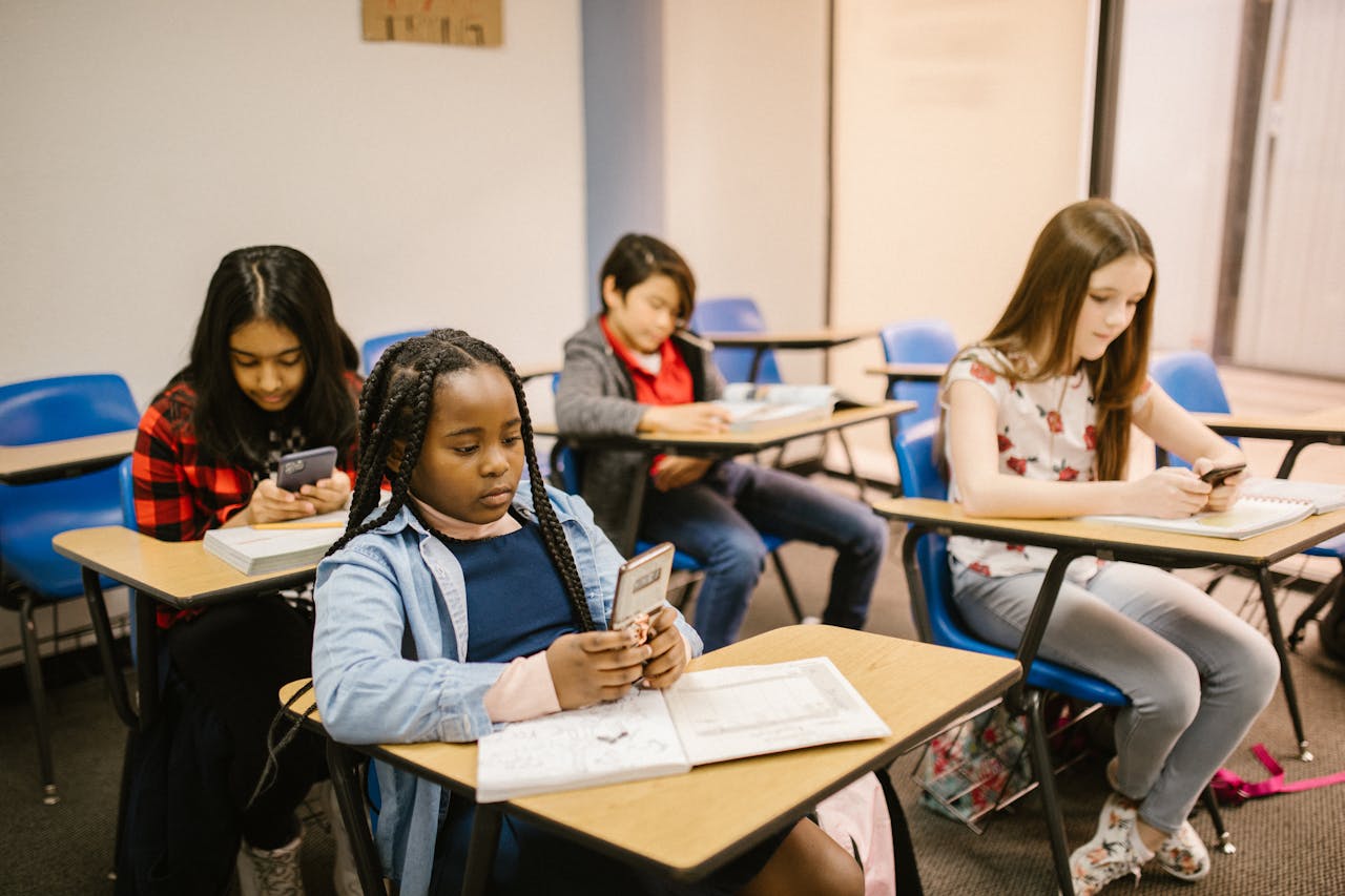 Students in a classroom using their smartphones