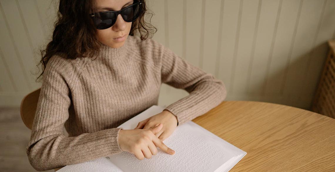 girl-braille-book a girl using a braille book